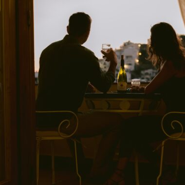 Propose marriage to your loved one on the terrace of a top like this ‘cheersing’ couple.